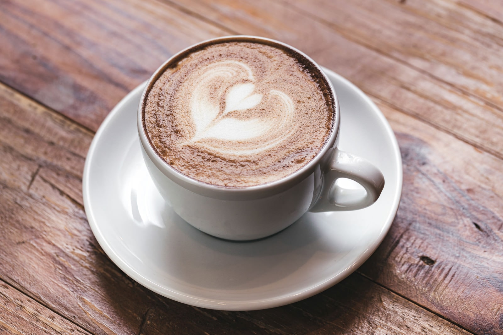 Cappuccino with foam art topping in a cup on a table